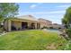 Lush backyard with a swimming pool, covered patio, and a well-maintained lawn for outdoor enjoyment at 1145 E Winchester Pl, Chandler, AZ 85286