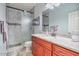 Bathroom featuring granite countertops, a sink, walk-in shower, and a framed mirror at 1145 E Winchester Pl, Chandler, AZ 85286
