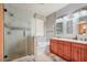 Stylish bathroom featuring double sinks, bathtub, granite countertop, and a large glass-enclosed shower at 1145 E Winchester Pl, Chandler, AZ 85286