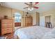 Bedroom with ensuite bathroom, multiple dressers and a large bed at 1145 E Winchester Pl, Chandler, AZ 85286