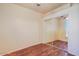 Cozy bedroom featuring sleek hardwood floors and a closet with mirrored sliding doors at 1145 E Winchester Pl, Chandler, AZ 85286