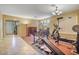 Spacious room with exercise equipment, neutral paint, and modern lighting with tile and wood flooring at 1145 E Winchester Pl, Chandler, AZ 85286