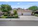 Traditional-style home featuring a manicured lawn, mature trees, and a convenient three-car garage at 1145 E Winchester Pl, Chandler, AZ 85286