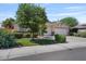 Lovely front yard with a mature tree, manicured lawn, and charming exterior stone accents at 1145 E Winchester Pl, Chandler, AZ 85286