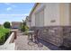 Inviting outdoor seating area on a brick patio, complemented by stone accents and green landscaping at 1145 E Winchester Pl, Chandler, AZ 85286
