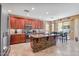Gourmet kitchen with granite counters, island with brick accents and stainless appliances at 1145 E Winchester Pl, Chandler, AZ 85286