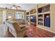Cozy living room with hardwood floors, built-in shelving, and comfortable seating arrangement at 1145 E Winchester Pl, Chandler, AZ 85286