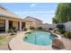 Inviting backyard pool with rock features, a desert landscape, and a covered patio for outdoor living at 1145 E Winchester Pl, Chandler, AZ 85286