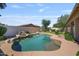 Tranquil pool with rock accents, set in a private backyard with desert-friendly landscaping and clear blue sky at 1145 E Winchester Pl, Chandler, AZ 85286