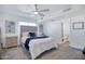 This bedroom features carpet, a ceiling fan, art, and ensuite bathroom entrance at 1211 N Miller Rd # 257, Scottsdale, AZ 85257