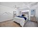 This carpeted bedroom features a ceiling fan, art, and nightstands at 1211 N Miller Rd # 257, Scottsdale, AZ 85257