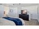 Carpeted bedroom features ensuite bathroom entrance and a dresser with a flat screen television at 1211 N Miller Rd # 257, Scottsdale, AZ 85257