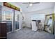 Bright bedroom features carpet, a ceiling fan, a work space, and a balcony access at 1211 N Miller Rd # 257, Scottsdale, AZ 85257