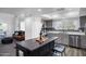 Open concept kitchen featuring a gray cabinets, island with seating and stainless steel appliances with natural light at 1211 N Miller Rd # 257, Scottsdale, AZ 85257