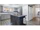 Stylish kitchen with a dark wood island, gray cabinets, stainless steel appliances, and a subway tile backsplash at 1211 N Miller Rd # 257, Scottsdale, AZ 85257