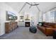 Bright living room featuring a vaulted ceiling, fireplace, and modern furnishings for a comfortable atmosphere at 1211 N Miller Rd # 257, Scottsdale, AZ 85257