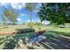 Exterior shot of park with walking paths, mature trees, grass, and seating areas and a clear blue sky at 1211 N Miller Rd # 257, Scottsdale, AZ 85257