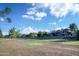 Exterior shot of park with long, lush grassy fields, walking paths, trees, and homes in the background at 1211 N Miller Rd # 257, Scottsdale, AZ 85257
