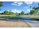 Exterior shot of park with walking path, mature trees, grass, and pond on a clear day at 1211 N Miller Rd # 257, Scottsdale, AZ 85257
