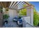 Inviting outdoor patio with pergola cover, cozy seating, and stylish decor for relaxing or entertaining at 1211 N Miller Rd # 257, Scottsdale, AZ 85257