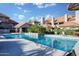 Community pool features palm trees, multiple lounge chairs and umbrellas with a relaxing oasis at 1211 N Miller Rd # 257, Scottsdale, AZ 85257