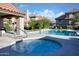 Community pool and hot tub surrounded by lush landscaping and multiple residences in a relaxing and sunny setting at 1211 N Miller Rd # 257, Scottsdale, AZ 85257