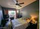 Cozy bedroom with a ceiling fan, wood floors, and view from the window at 1222 W Baseline Rd # 163, Tempe, AZ 85283