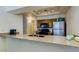 Kitchen area featuring stone counter tops, stainless steel appliances, and modern lighting at 1222 W Baseline Rd # 163, Tempe, AZ 85283