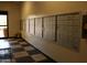 Mailboxes lined neatly along a wall in a well-lit entryway with tiled flooring at 12221 W Bell Rd # 363, Surprise, AZ 85378
