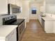 Modern kitchen featuring stainless steel appliances, white cabinets, and luxury vinyl plank flooring at 13106 W Calavar Rd, Surprise, AZ 85379