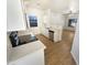 Modern kitchen featuring white cabinets, stainless steel appliances, and luxury vinyl plank flooring at 13106 W Calavar Rd, Surprise, AZ 85379
