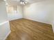 Spacious room with luxury vinyl plank flooring and a view of a half wall to the kitchen at 13106 W Calavar Rd, Surprise, AZ 85379