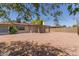 Spacious backyard featuring rock landscaping, a covered patio, and a block fence at 137 W Wagoner Rd, Phoenix, AZ 85023