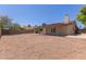 Expansive gravel backyard with mature trees and patio, offering privacy and a low maintenance space at 137 W Wagoner Rd, Phoenix, AZ 85023