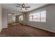 Bedroom with mirrored closet, large window, and ceiling fan at 137 W Wagoner Rd, Phoenix, AZ 85023