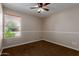 Cozy bedroom featuring neutral walls, brown carpet, a window with blinds, and a ceiling fan with lighting at 137 W Wagoner Rd, Phoenix, AZ 85023