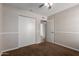 Bedroom features a closet with white sliding doors and neutral walls over brown carpet flooring at 137 W Wagoner Rd, Phoenix, AZ 85023