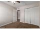 Bedroom featuring neutral walls, brown carpet, a closet, and an open door at 137 W Wagoner Rd, Phoenix, AZ 85023