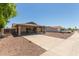 Single-story home with covered parking and desert landscaping on a sunny day at 137 W Wagoner Rd, Phoenix, AZ 85023