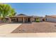 Charming single-story home with a large covered parking area, desert landscaping, and welcoming front entrance at 137 W Wagoner Rd, Phoenix, AZ 85023