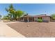 Charming single-story home with a large covered parking area, desert landscaping, and welcoming front entrance at 137 W Wagoner Rd, Phoenix, AZ 85023