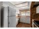 Bright kitchen featuring white appliances, wooden countertops, and ample natural light from above skylight at 137 W Wagoner Rd, Phoenix, AZ 85023