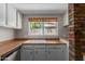 Bright kitchen with white cabinets, wood countertops, and a window with backyard view at 137 W Wagoner Rd, Phoenix, AZ 85023