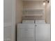 Laundry room featuring shelving over a white washer and dryer set at 137 W Wagoner Rd, Phoenix, AZ 85023