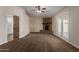 Spacious living room with a ceiling fan, brick fireplace and access to the backyard through glass doors at 137 W Wagoner Rd, Phoenix, AZ 85023