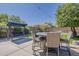 Relaxing backyard area with dining table, lounge swing, and well-manicured lawn at 1441 E Folley Pl, Chandler, AZ 85225