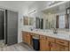 Bright bathroom featuring a double vanity, large mirror, and modern fixtures at 1441 E Folley Pl, Chandler, AZ 85225
