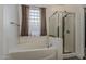 Bathroom with a glass block window providing natural light above the jetted tub at 1441 E Folley Pl, Chandler, AZ 85225