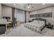 Spacious bedroom featuring a ceiling fan, dedicated desk area, and dark-toned furniture at 1441 E Folley Pl, Chandler, AZ 85225