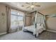 Bedroom with a canopy bed, flowing curtains, and plenty of natural light from a large window at 1441 E Folley Pl, Chandler, AZ 85225